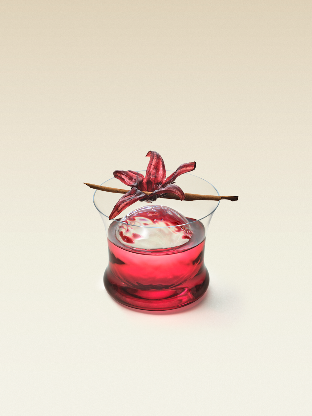 A short glass with one large round ice cube and lime slice with with a candied hibiscus flower and sprig of cinnamon as garnish, displaying a hibiscus tequila cocktail.