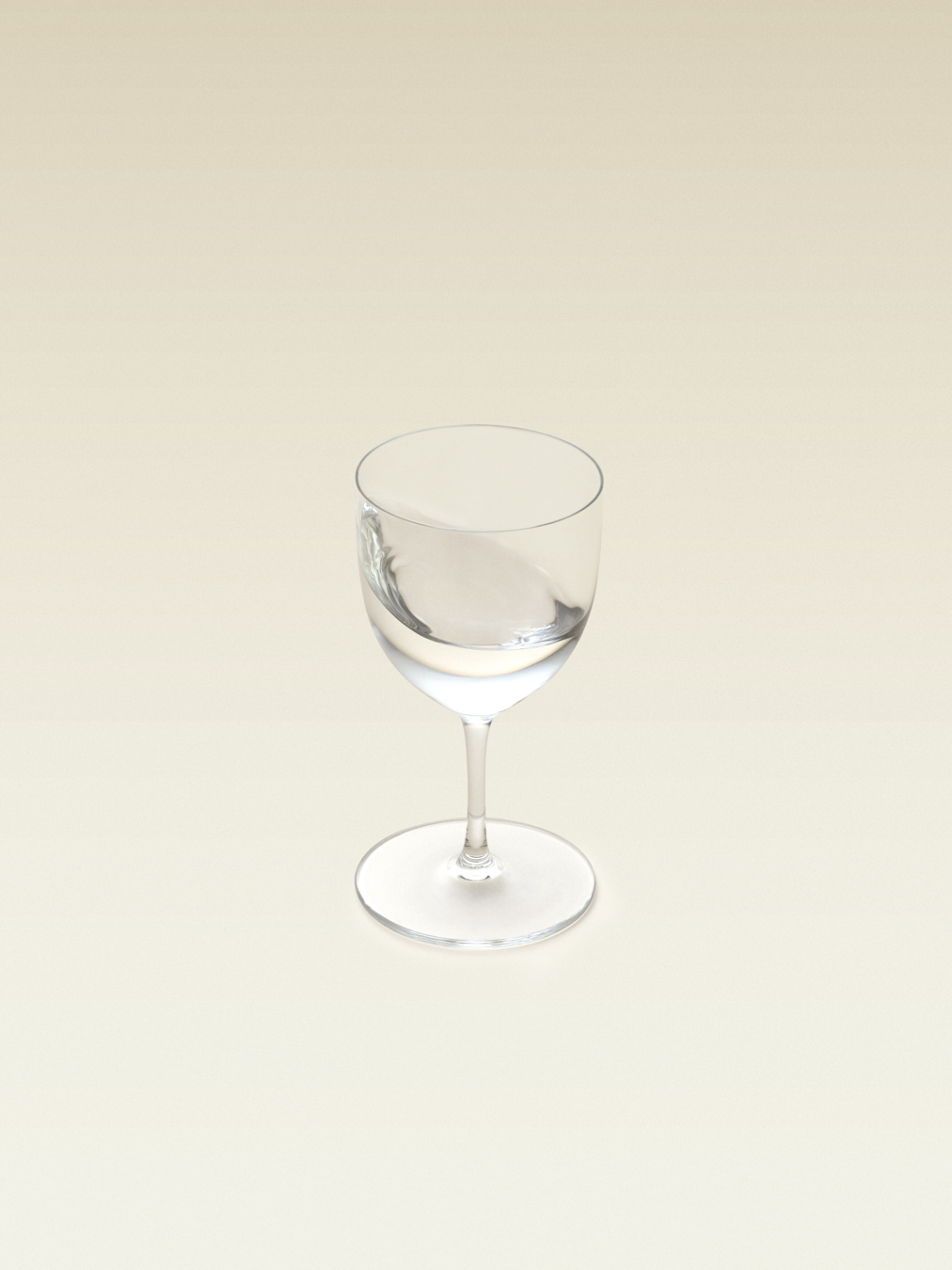 A tulip shaped glass with clear liquid inside, displaying a sipping tequila glass with clear, blanco tequila inside.