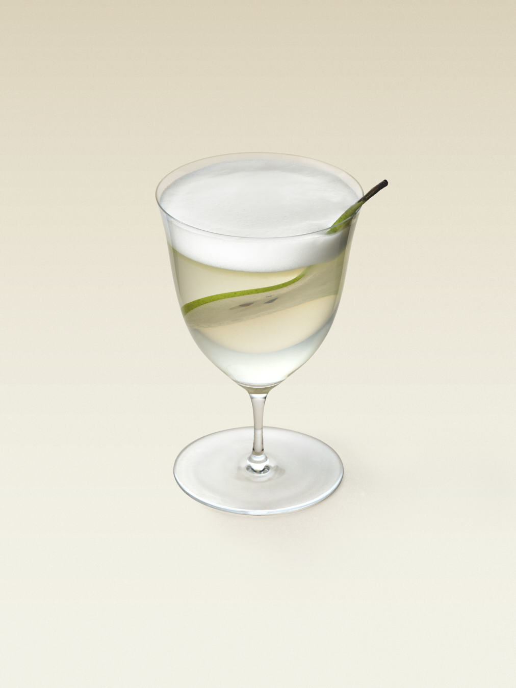 A tulip shaped glass with light green liquid and a thin slide of pear, topped with coconut foam, displaying a pear and coconut cocktail. 